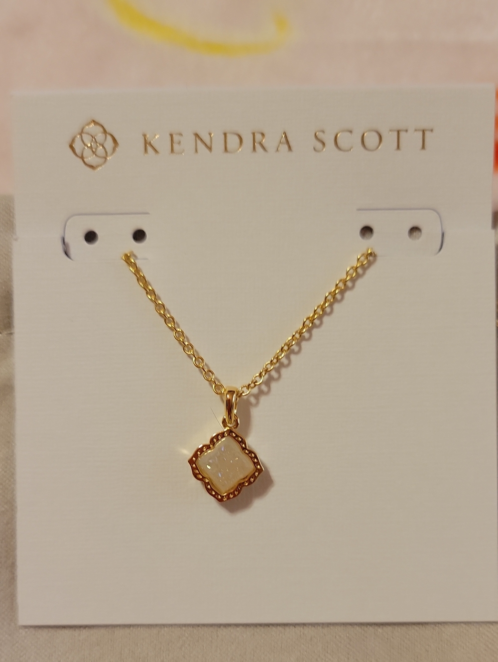 Kendra Scott Gold Necklace with White Iridescent Quatrefoil Pendant